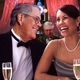 David Koch charms a beautiful socialite with flirtatious banter, while brother Charles awaits his cue to step in and astound her with his knowledge of free enterprise.